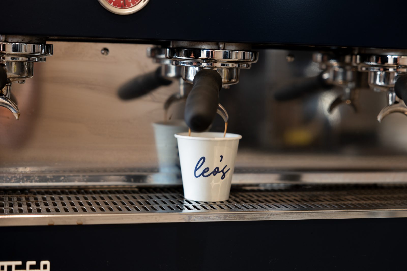 Espresso pouring from a La Marzocco into a Leo's cup