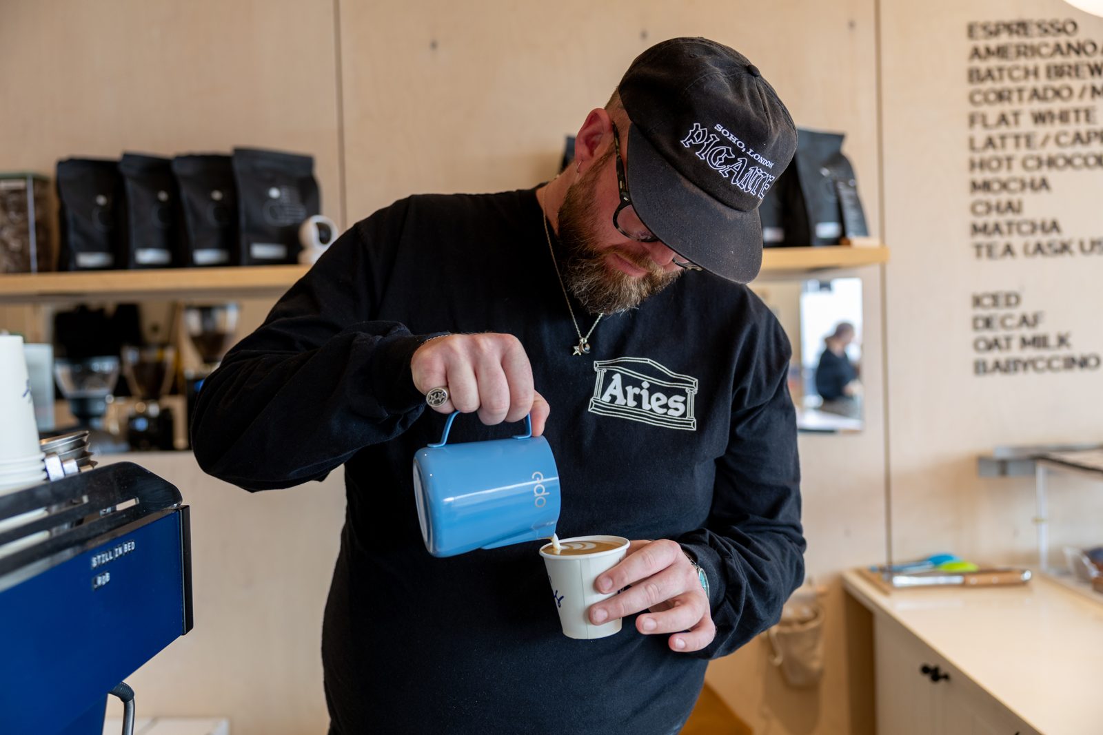 A Leo's barista pouring latte art at the Camber bar